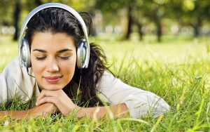 Girl-relaxing-on-the-Grass-with-Music-600x375