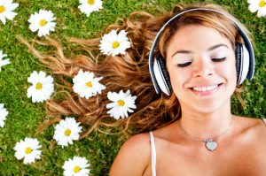 Woman listening to music with headphones outdoors